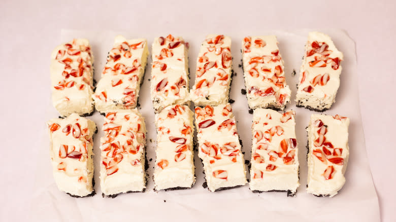 sliced cheesecake bars on parchment paper