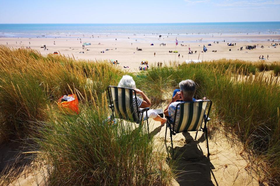 People enjoy the warm weather at Camber, East Sussex (PA)