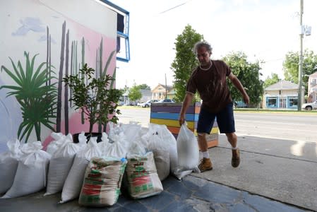 Herman Krom sets sandbags in front of his business as Tropical Storm Barry approaches land in New Orleans