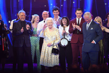 Britain's Queen Elizabeth waves to the audience during a special concert "The Queen's Birthday Party" to celebrate her 92nd birthday at the Royal Albert Hall in London, Britain April 21, 2018. Andrew Parsons/Pool via Reuters