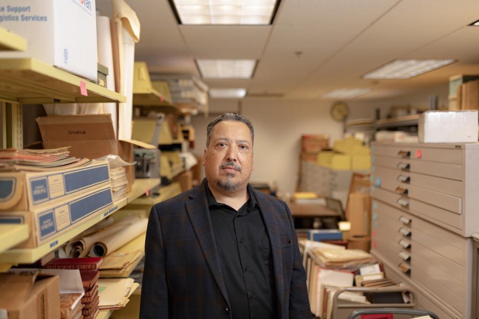 Alexandro Gradilla stands inside a room