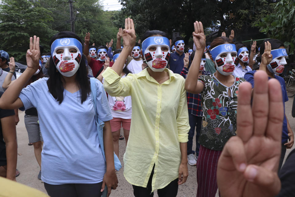 Young demonstrators flash the three-fingered symbol of resistance during an anti-coup mask strike in Yangon, Myanmar, Sunday, April 4, 2021. Threats of lethal violence and arrests of protesters have failed to suppress daily demonstrations across Myanmar demanding the military step down and reinstate the democratically elected government. (AP Photo)