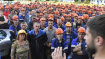 Workers of the Grodno Azot Plant listen to a speaker during a strike in Grodno, 246 kilometers (154 miles) west of Minsk, Belarus, Wednesday, Aug. 19, 2020. The authoritarian leader of Belarus complained that encouragement from abroad has fueled daily protests demanding his resignation as European Union leaders held an emergency summit Wednesday on the country's contested presidential election and fierce crackdown on demonstrators. (AP Photo/Viktor Drachev)