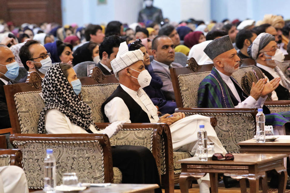 Afghan President Ashraf Ghani, center left, wears a protective face mask to help curb the spread of the coronavirus, on the last day of an Afghan Loya Jirga or traditional council, in Kabul, Afghanistan, Sunday, Aug. 9, 2020. The council concluded Sunday with hundreds of delegates agreeing to free 400 Taliban members, paving the way for an early start to negotiations between Afghanistan's warring sides. (AP Photo)