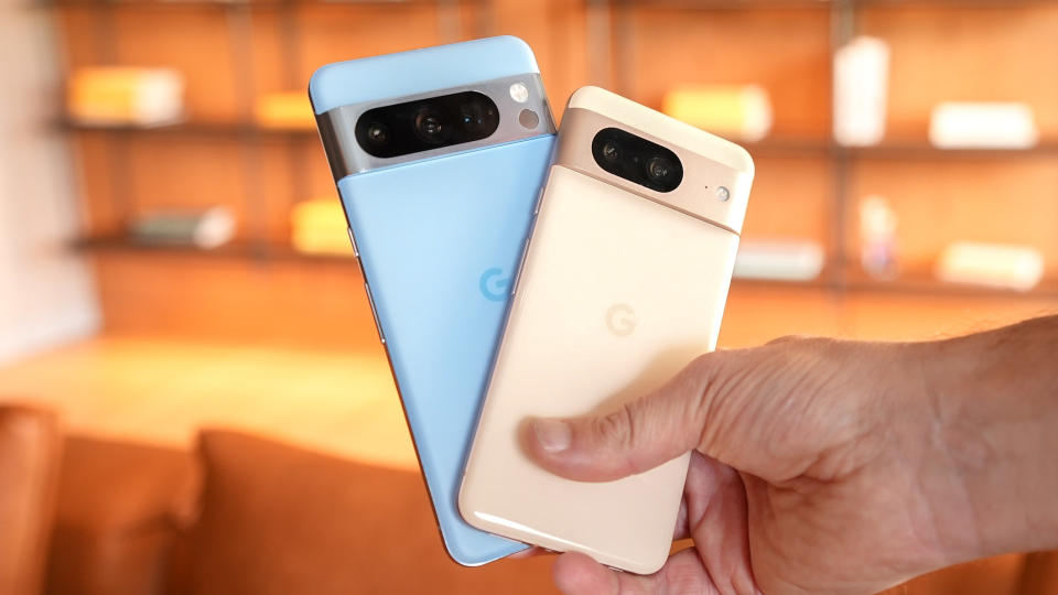 Google Pixel 8 and Pixel 8 Pro held in the hand.