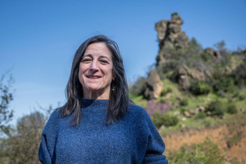 Sandra Schubert, executive director of nonprofit conservation organization Tuleyome, stands near a rock formation at Molok Luyuk on the border of Lake and Colusa counties on April 14.