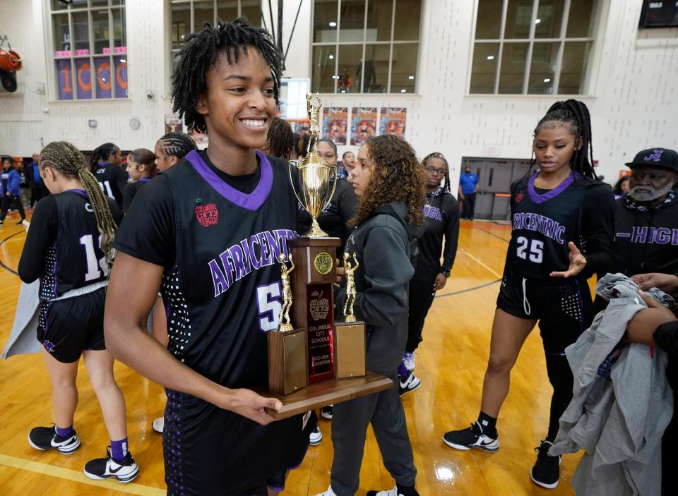 Africentric's Samairah Thompson holds the City League championship trophy after the Nubians beat Centennial 81-48 in the title game Saturday at East.