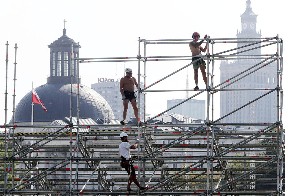 Workers erect a stage ahead of upcoming ceremonies marking the 80th anniversary of the start of World War II, to be attended by world leaders including President Donald Trump, in Warsaw, Poland, Wednesday, Aug. 28, 2019.(AP Photo/Czarek Sokolowski)