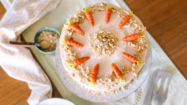 Vegan carrot cake with cinnamon-cashew frosting on table