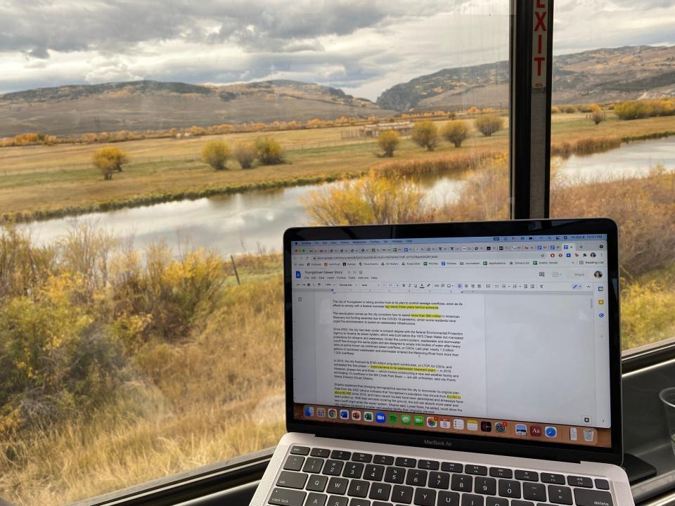 laptop set up in front of a window on an amtrak train