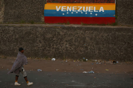 A man walks at the border between Brazil and Venezuela in Pacaraima, Roraima state, Brazil February 24, 2019. REUTERS/Bruno Kelly