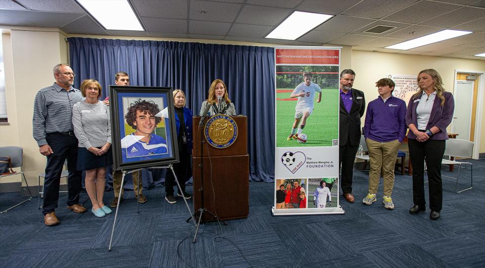 Rep. Kim Moser, R-Taylor Mill, center, stood with the Batson and Mangine families after Moser held a press conference to announce she is joining forces on an AED bill (House Bill 331) filed last week by Rep. Ruth Ann Palumbo, D-Lexington. Both families suffered the loss of a family member due to sudden death in sport. Feb. 21, 2023 