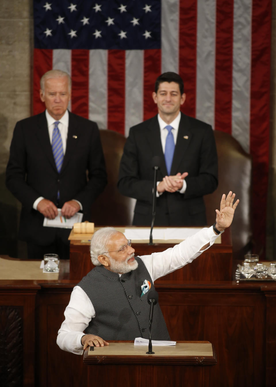 Vice President Joe Biden, left, and Speaker of the House Paul Ryan look on as India Prime Minister Narendra Modi acknowledges applause as he arrives to address a joint meeting of Congress in the House chamber on Capitol Hill in Washington&nbsp;on&nbsp;June 8, 2016.