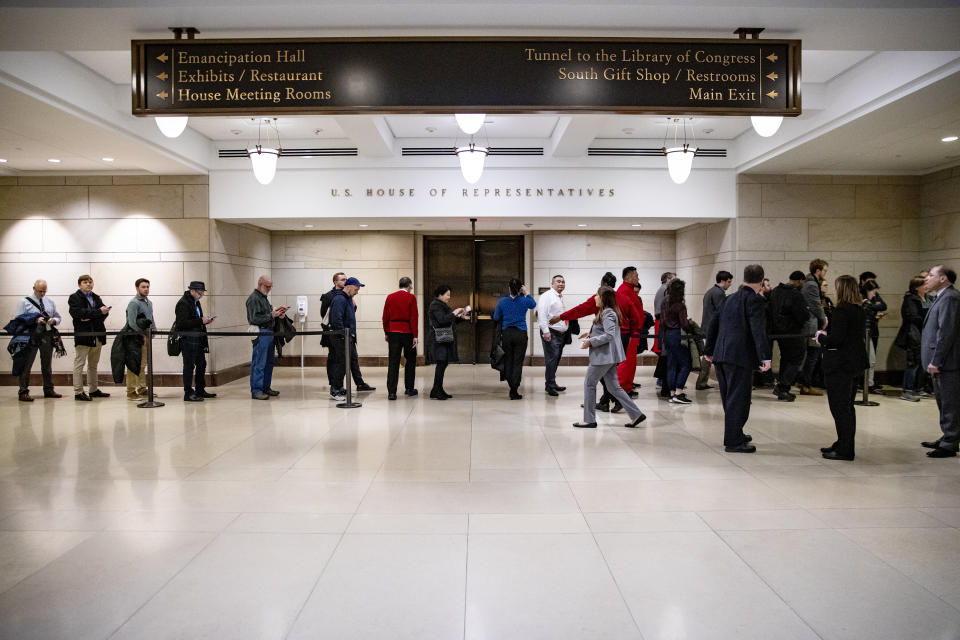 Tourists wait in line for a chance to get into the House chamber to watch lawmakers vote to impeach President Donald Trump. (Photo: Samuel Corum via Getty Images)