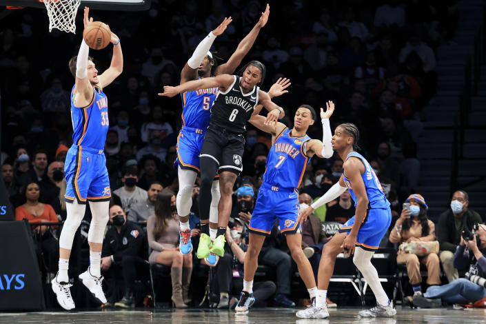 Brooklyn Nets forward David Duke Jr. (6) attempts to pass while being defended by Oklahoma City Thunder center Mike Muscala (33), Oklahoma City Thunder forward Luguentz Dort (5), Oklahoma City Thunder forward Darius Bazley (7), and Oklahoma City Thunder guard Shai Gilgeous-Alexander (2) during the first half of an NBA basketball game, Thursday, Jan. 13, 2022, in New York. (AP Photo/Jessie Alcheh)