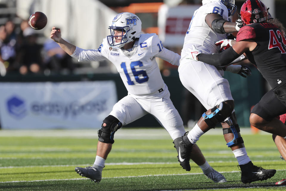 Middle Tennessee quarterback Chase Cunningham (16) fumbles the ball during the first half of the Hawaii Bowl NCAA college football game against San Diego State, Saturday, Dec. 24, 2022, in Honolulu. (AP Photo/Marco Garcia)