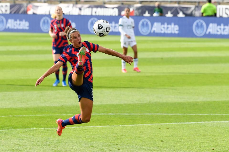 Carli Lloyd looks to settle the ball.