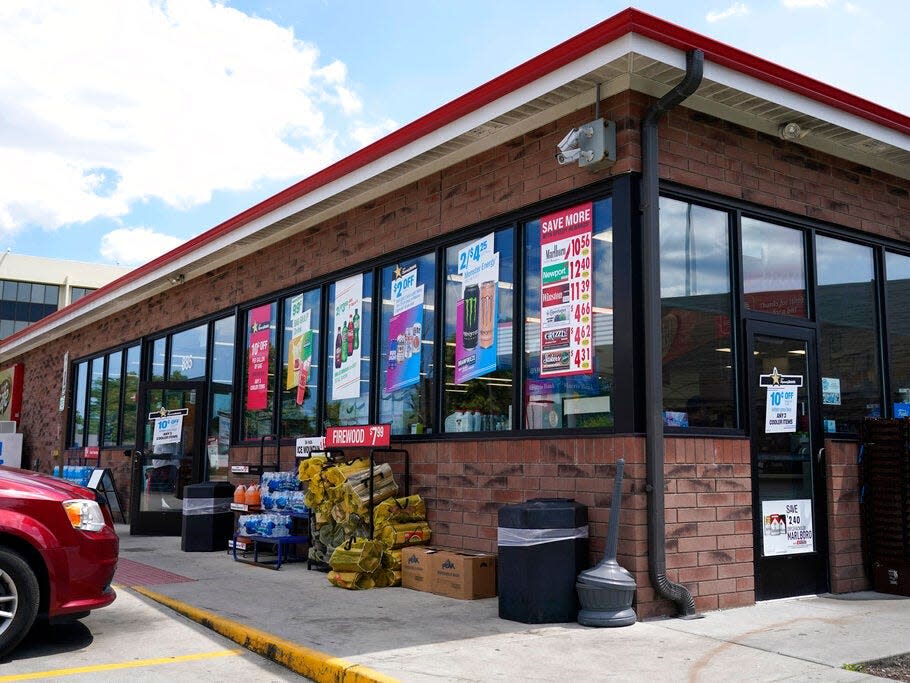 Vehicles are parked outside the Illinois Speedway gas station in Des Plaines, Ill., where the winning Mega Millions lottery ticket was sold, Saturday, July 30, 2022.