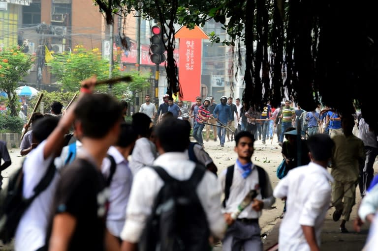 Students could be seen clashing with unidentified men who wielded clubs and stones