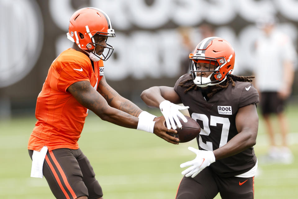 Cleveland Browns quarterback Deshaun Watson hands off to running back Kareem Hunt (27) during the NFL football team's training camp, Tuesday, Aug. 9, 2022, in Berea, Ohio. (AP Photo/Ron Schwane)