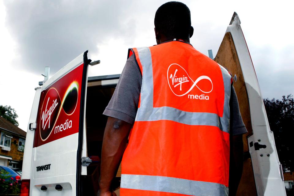 A Virgin Media employee delivering a digital tv reciever. (Newscast Limited via AP Images)