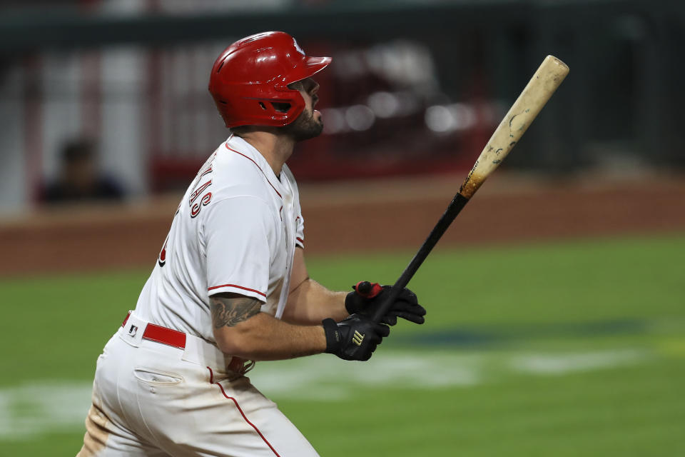 Cincinnati Reds' Mike Moustakas watches his three-run home run in the eighth inning during a baseball game against the Milwaukee Brewers in Cincinnati, Monday, Sept. 21, 2020. (AP Photo/Aaron Doster)