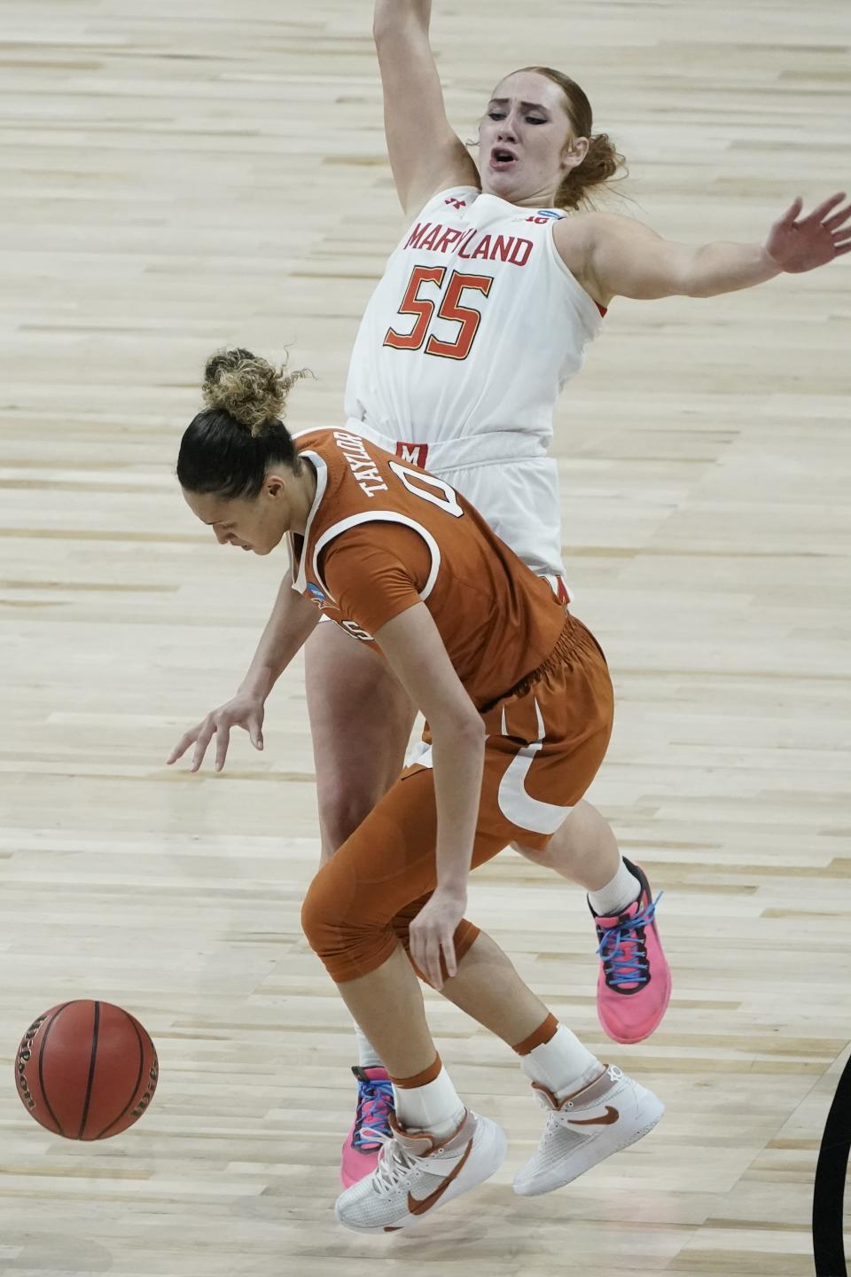 Maryland's Chloe Bibby tries to draw a charge on Texas's Celeste Taylor during the second half of an NCAA college basketball game in the Sweet 16 round of the Women's NCAA tournament Sunday, March 28, 2021, at the Alamodome in San Antonio. (AP Photo/Morry Gash)