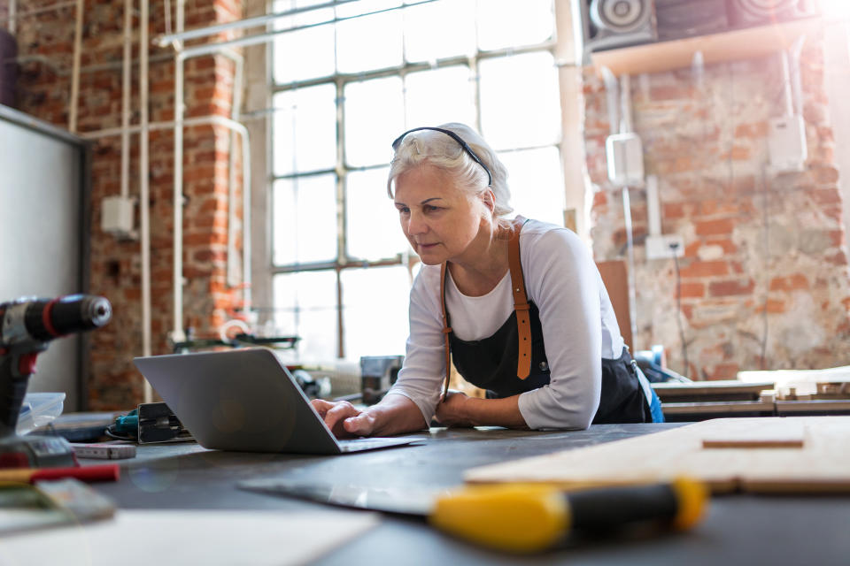 Confident senior woman working in workshop