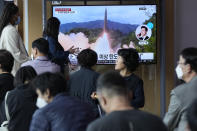 People watch a news program showing a file image of a missile launch by North Korea at the Seoul Railway Station in Seoul, South Korea, Sunday, Sept. 25, 2022. North Korea fired a short-range ballistic missile Sunday toward its eastern seas, extending a provocative streak in weapons testing as a U.S. aircraft carrier visits South Korea for joint military exercises in response to the North's growing nuclear threat. (AP Photo/Ahn Young-joon)