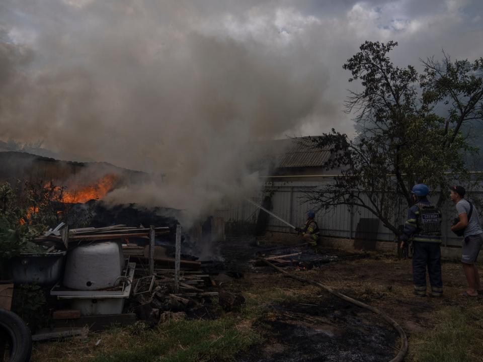 A house burst into flames after cluster rockets hit Konstantinovka (AP)