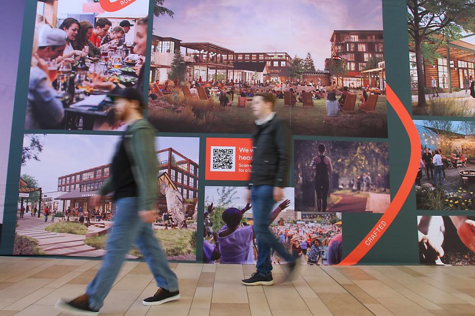 Mall patrons walk past architectural renderings during a public open house held by McWhinney and Prism Places at the Foothills Mall on Saturday April 15. Developers McWhinney and Prism Places purchased the 63-acre midtown property in June 2021.