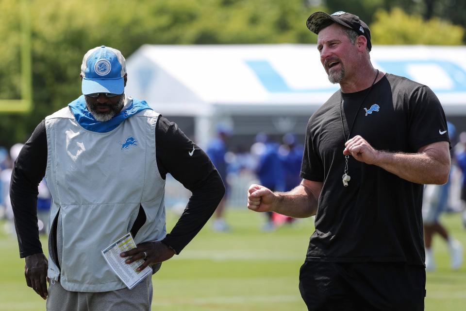 Detroit Lions head coach Dan Campbell talks to general manager Brad Holmes after the joint practice with New York Giants at Detroit Lions headquarters and training facility in Allen Park on Tuesday, August 8, 2023.