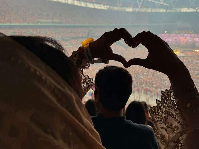 <p>Malala Yousafzai/Instagram</p> Malala Yousafzai making heart hands at a Taylor Swift concert in London