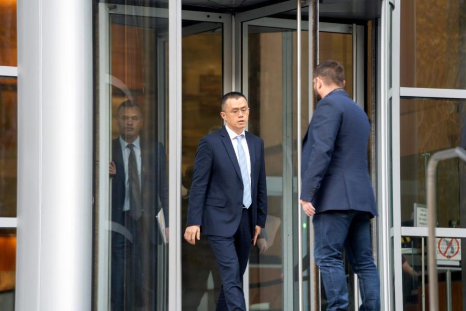 Changpeng Zhao, chief executive officer of Binance Holdings Ltd., center, exits federal court in Seattle, Washington, US, on Tuesday, Nov. 21, 2023. Zhao pleaded guilty to anti-money laundering violations and agreed to pay a $50 million fine Tuesday under a sweeping deal worked out with the Justice Department designed to keep the company operating. Photographer: Chloe Collyer/Bloomberg via Getty Images