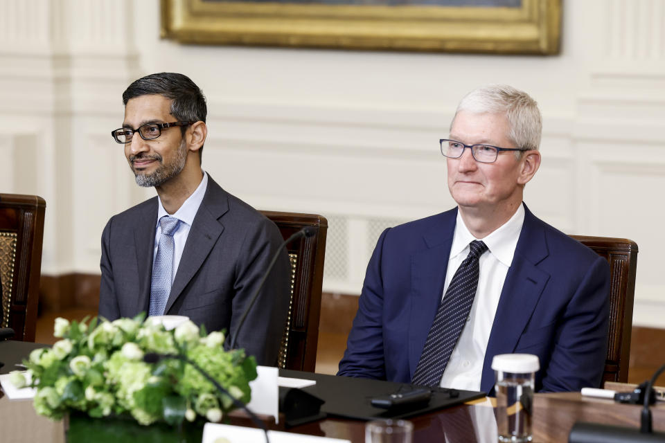 WASHINGTON, DC - JUNE 23: Google CEO Sundar Pichai (L) and Apple CEO Tim Cook (R) listen as U.S. President Joe Biden speaks during a roundtable with American and Indian business leaders in the East Room of the White House on June 23, 2023 in Washington, DC. Biden and Indian Prime Minister Narendra Modi held the meeting to meet with a range of leaders from the tech and business worlds and to discuss topics including innovation and AI. (Photo by Anna Moneymaker/Getty Images)