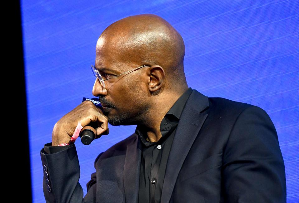 Van Jones holds a microphone while speaking at an event
