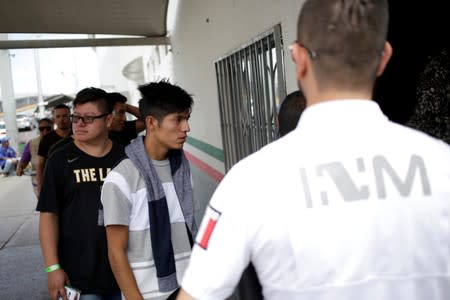 Mexican migrants deported from the U.S. arrive to an office of the National Migration Institute at Paso del Norte International border bridge in Ciudad Juarez
