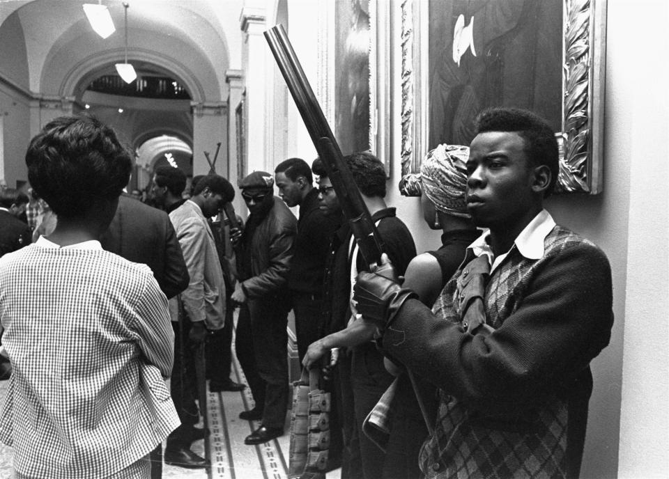 Armed members of the Black Panthers Party gather in the corridor of the Capitol in Sacramento, California, on May 2, 1967, to protest a bill restricting the carrying of arms in public.