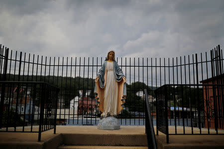 FILE PHOTO: A statue of the Virgin Mary is seen in front of Charles Borromeo Parish church, formerly St. Joseph in Ashland, Pennsylvania, U.S., August 17, 2018. REUTERS/Carlos Barria