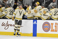 Vegas Golden Knights center Jack Eichel (9) celebrates with the bench after scoring against the Seattle Kraken during the first period of an NHL hockey game Thursday, March 21, 2024, in Las Vegas. (AP Photo/David Becker)