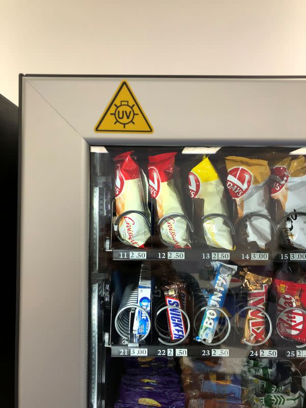 A vending machine installed with UV lights for sanitization is seen at Ericsson's office in Bucharest