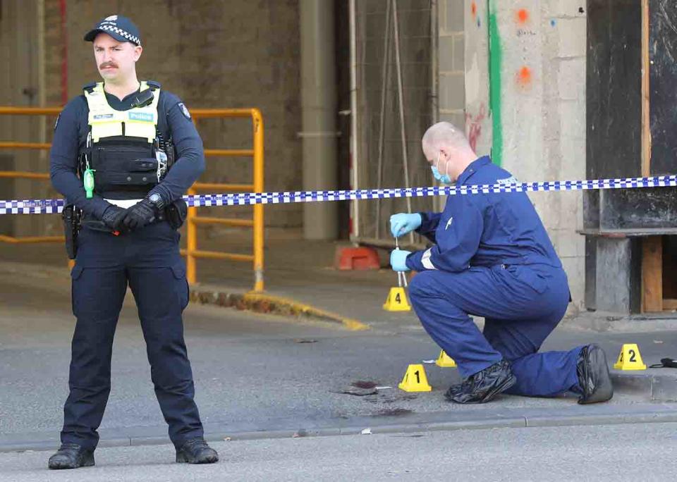 Police inspect the scene near Flinders Street in Melbourne's CBD, where fugitive Jonathan Dick was arrested.