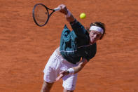 Andrey Rublev, of Russia, serves a ball to Taylor Fritz, of United States, during the Mutua Madrid Open tennis tournament in Madrid, Spain, Friday, May 3, 2024. (AP Photo/Bernat Armangue)
