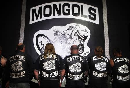 Members of the Mongols Motorcycle Club, display their club's emblem on the back of their jackets as they pose for a photograph in their clubhouse located in western Sydney November 9, 2014. REUTERS/David Gray