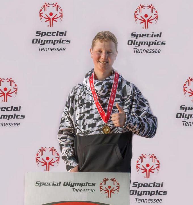 <strong><em>Chris Furches at the podium with one of his two Tennessee Special Olympics snowboarding golds. (Stephanie Furches)</em></strong>