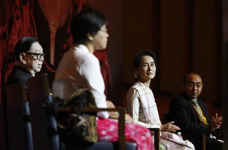 Myanmar's opposition leader Aung San Suu Kyi (2nd R) waits to speak to the Myanmar community living in Singapore on the island of Sentosa in Singapore September 22, 2013. REUTERS/Edgar Su