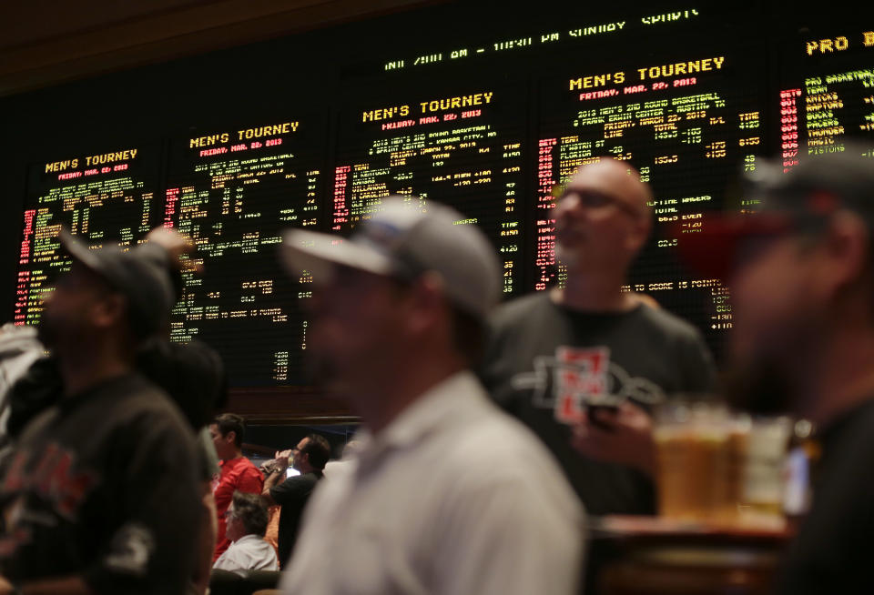 Fans watch the 2013 NCAA tournament at the Mirage in Las Vegas. (AP Photo/Julie Jacobson)