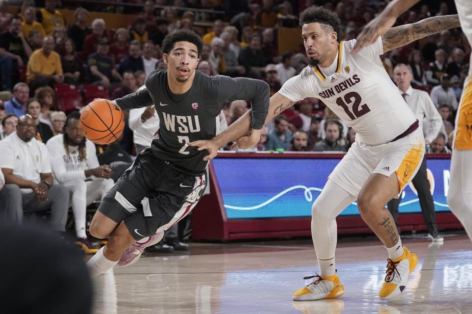 Washington State guard Myles Rice (2) drives past Arizona State guard Jose Perez (12) during the first half of an NCAA college basketball game Saturday, Feb. 24, 2024, in Tempe, Ariz. (AP Photo/Darryl Webb)