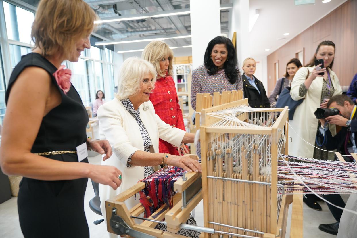 Queen Camilla joins Global Chief Executive officer of Chanel, Leena Nair,  and tries her hand at weaving tweed on a traditional loom in the Maison Lesage (Yui Mok/PA Wire)