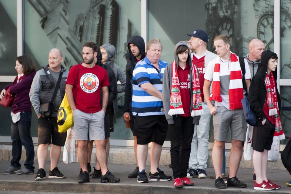 Liverpool fans making their way back home from John Lennon Airport after the UEFA Champions League Final (PA)
